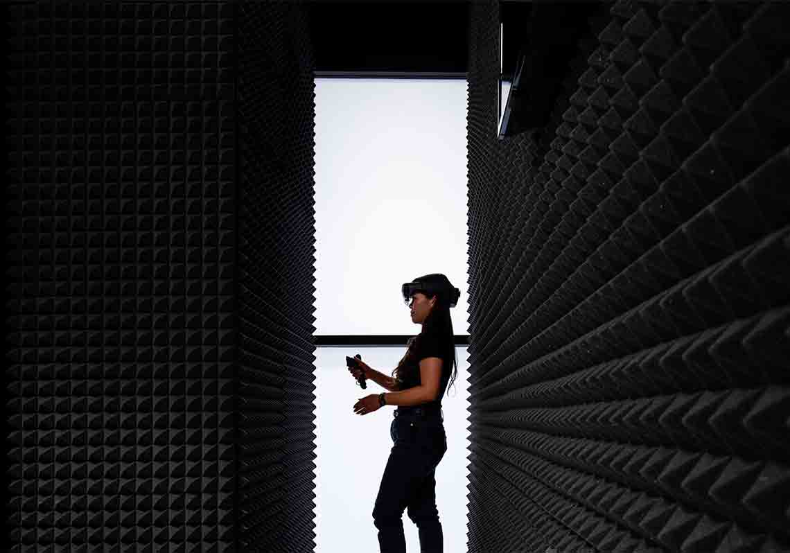 Woman exploring in VR headset at an office facility (Tier 1_Office_Houston_AML_4962)
