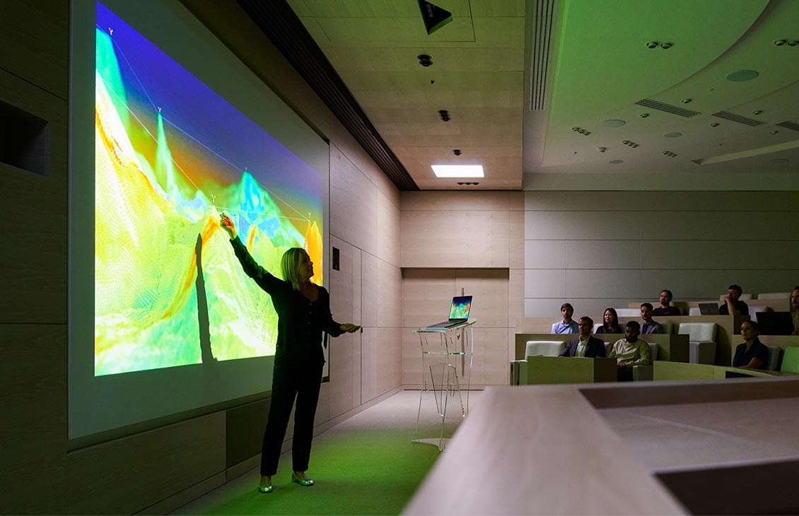 Woman giving a presentation to a crowd in an auditorium
