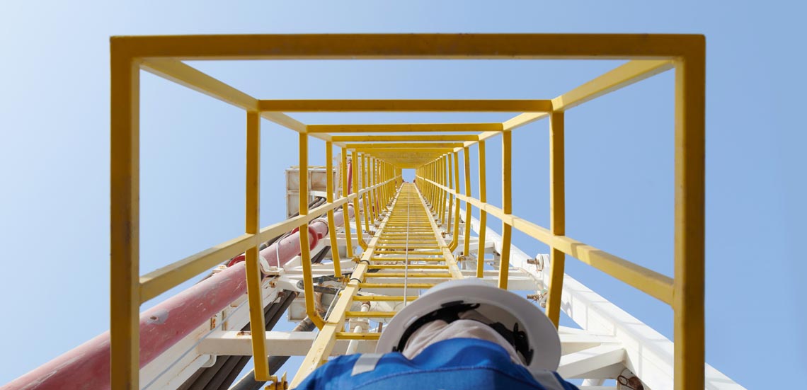 Operator looking up through a land rig ladder cage
