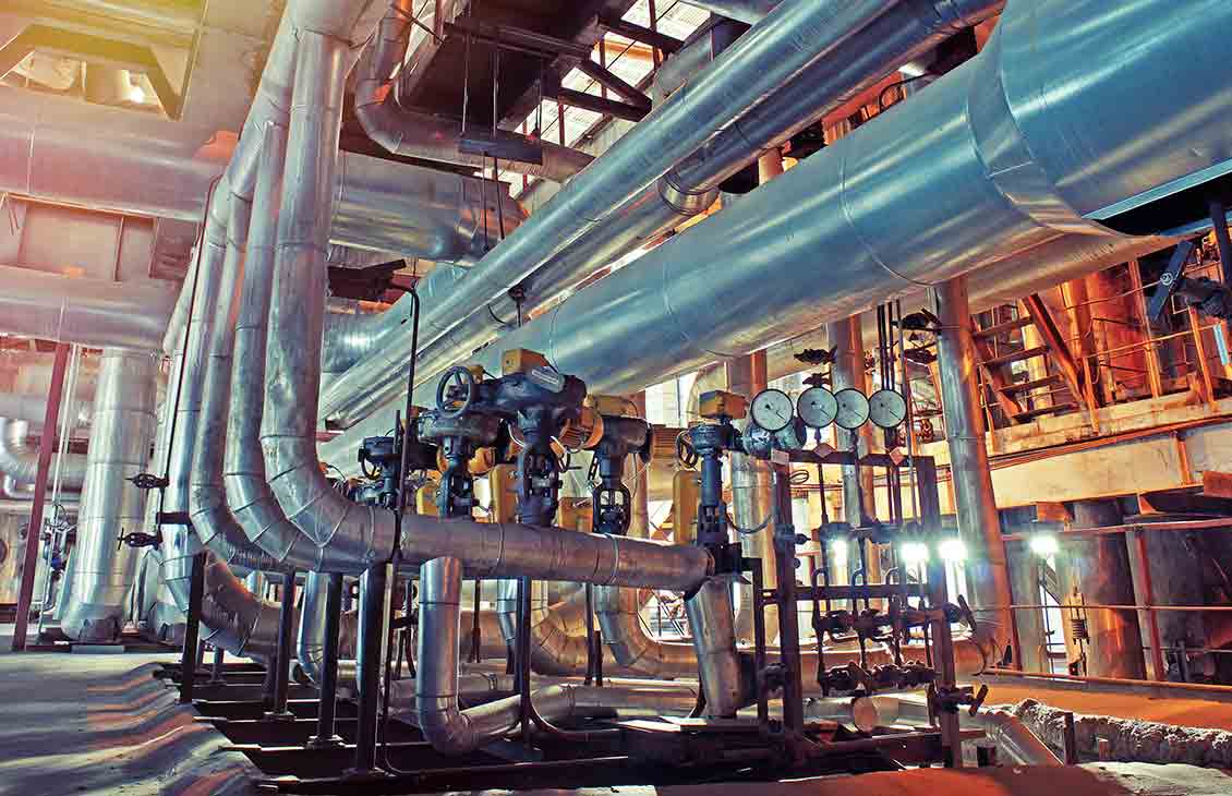 Equipment, cables and piping as found inside of a modern industrial plant