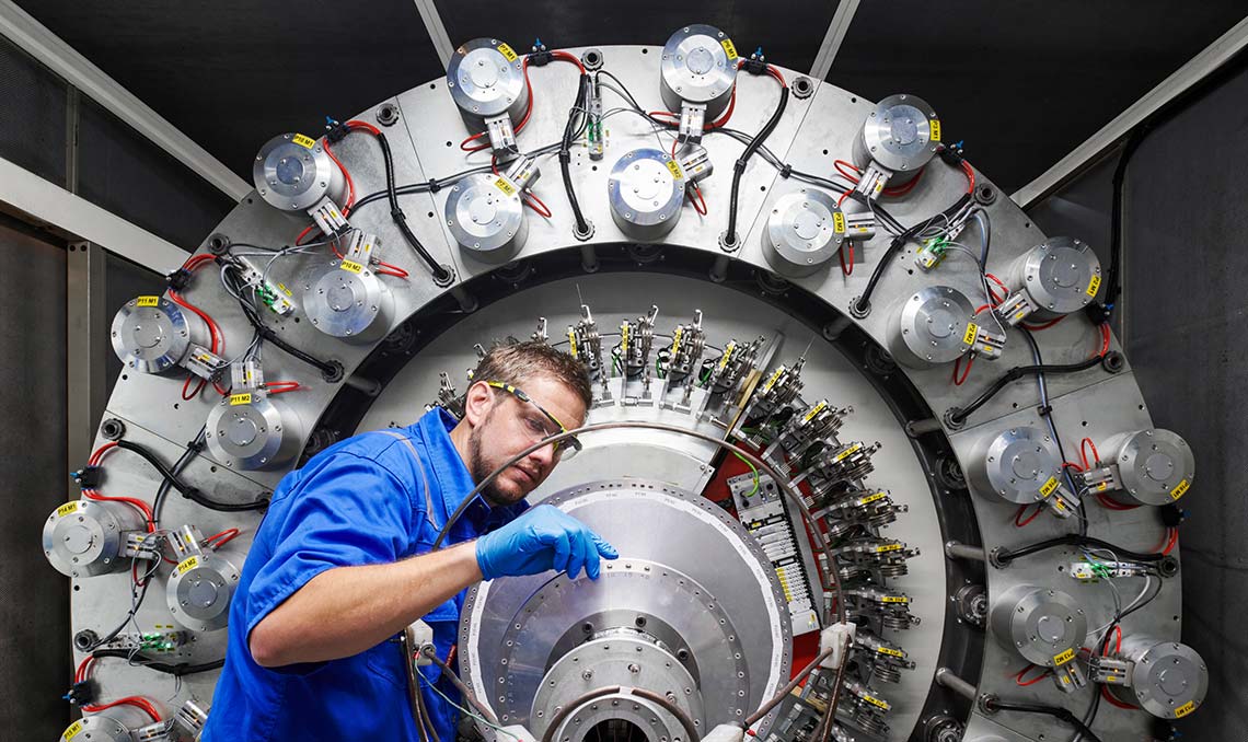 Male engineer working on a big piece of equipment (Tier 1_ManufacturingFacility_SugarLand_AML_5220)