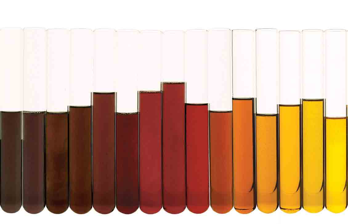 Test tubes holding different weights of oil, arranged from darkest to lightest.